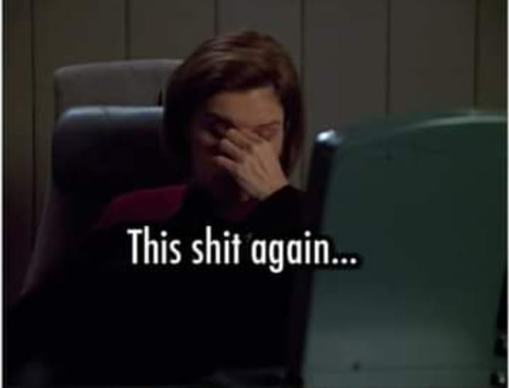 Janeway holding her head in hand.
